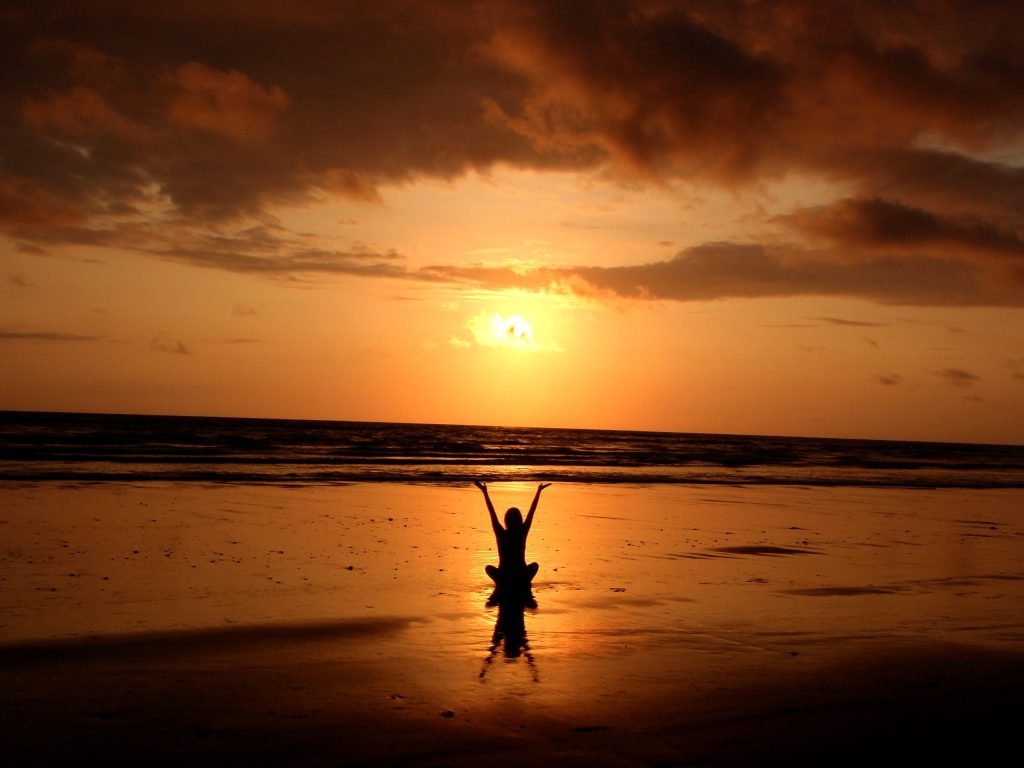 person on beach sunset