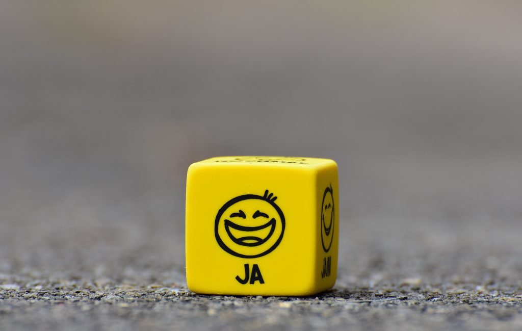 yellow dice with a happy face.