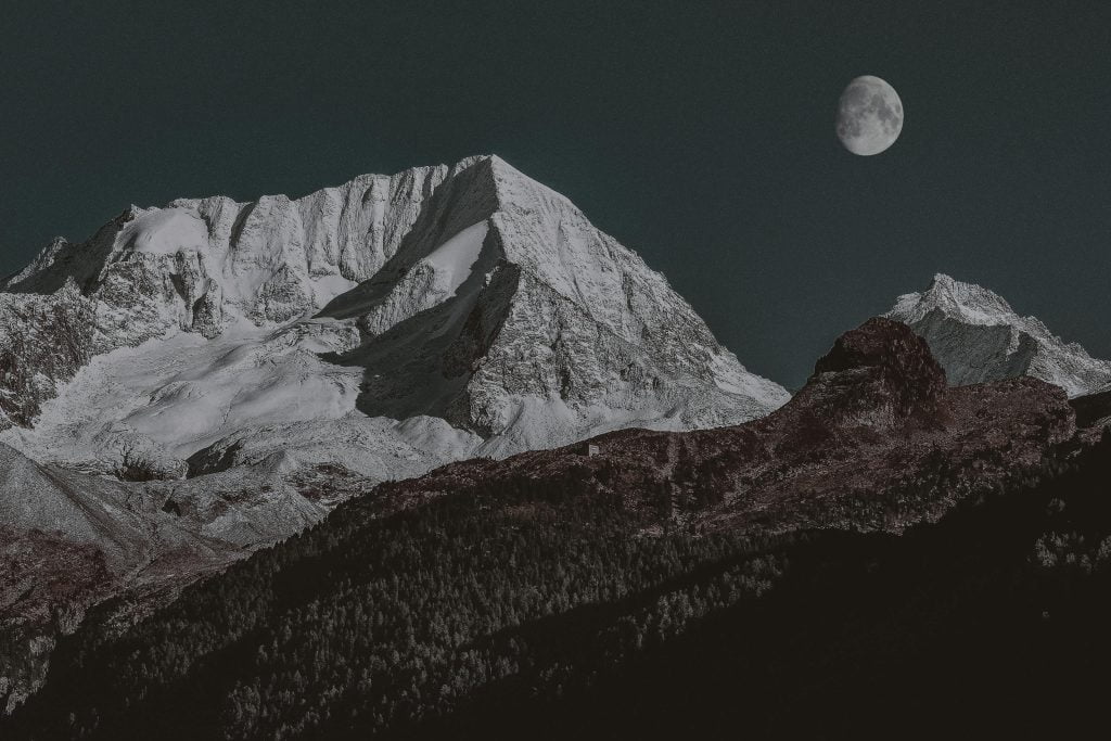 The moon over tall mountains
